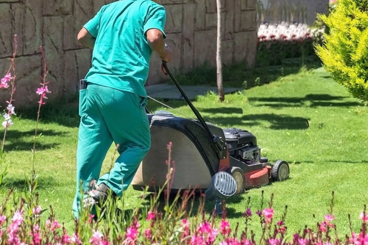 The owner of K&C Yard Care mowing a clients yard.